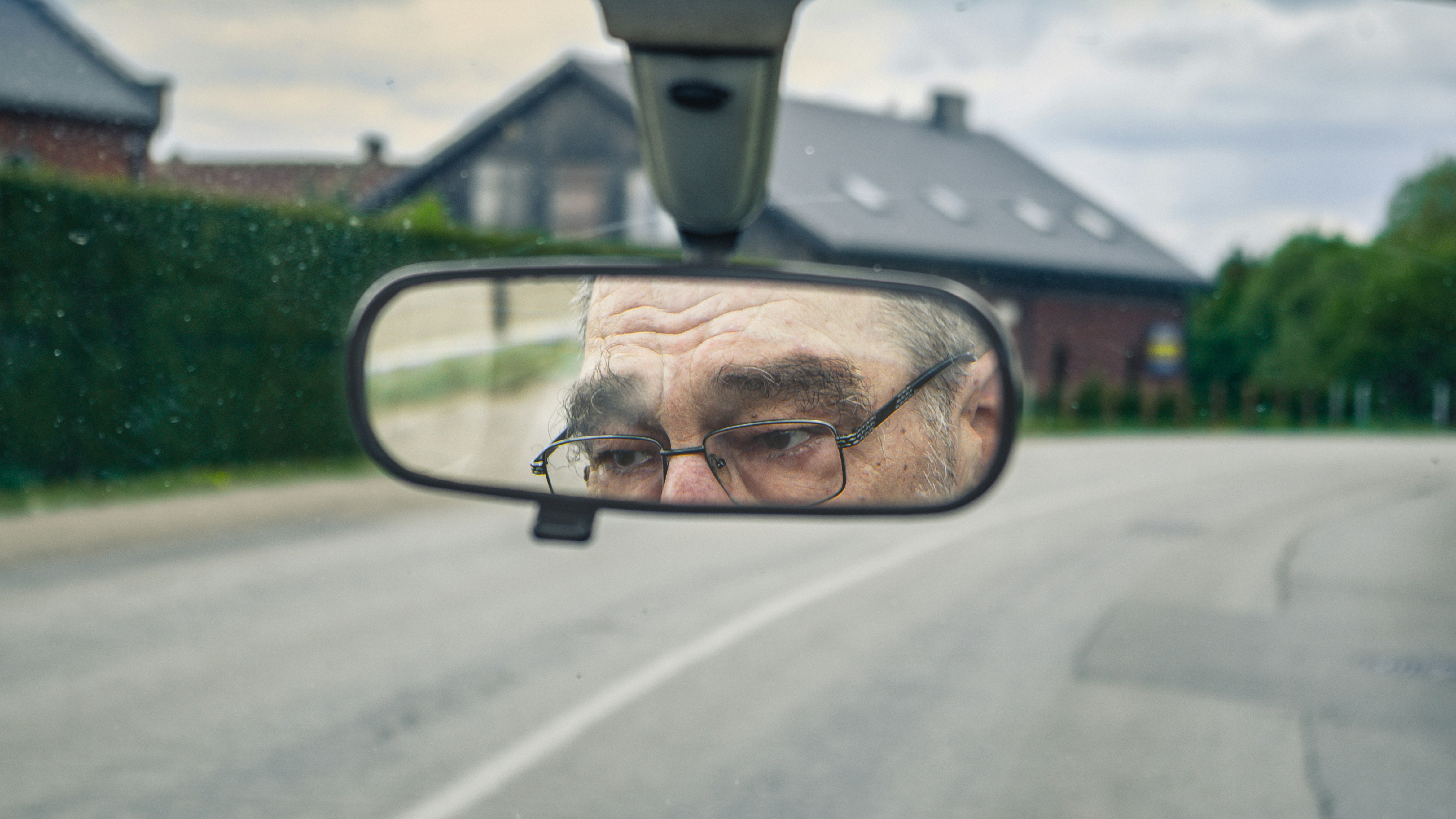 black framed eyeglasses on car rear mirror